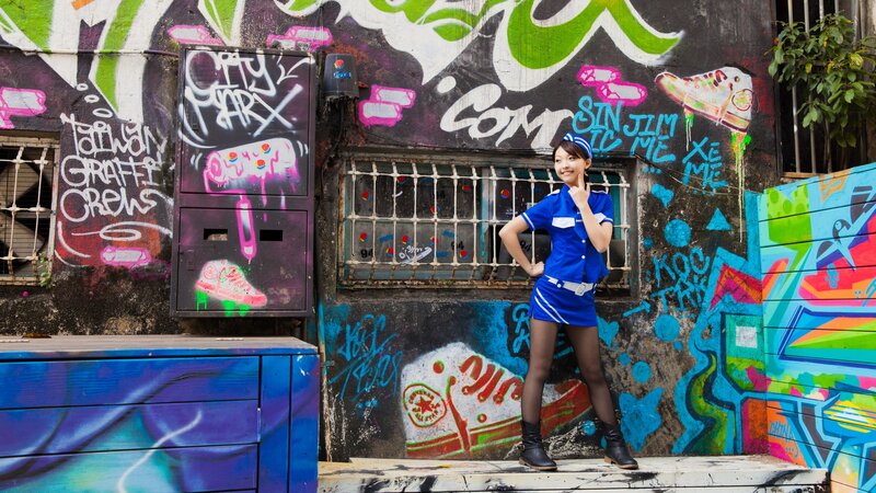 Woman in blue uniform with graffiti