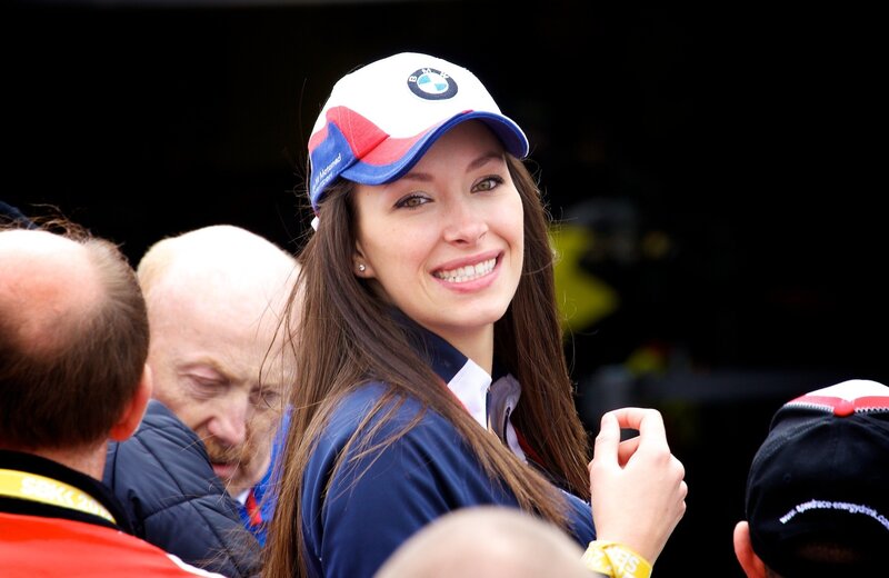 Woman in BMW cap smiling