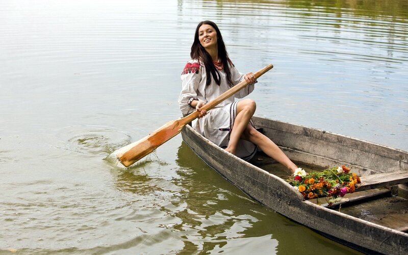 Woman in boat with flowers