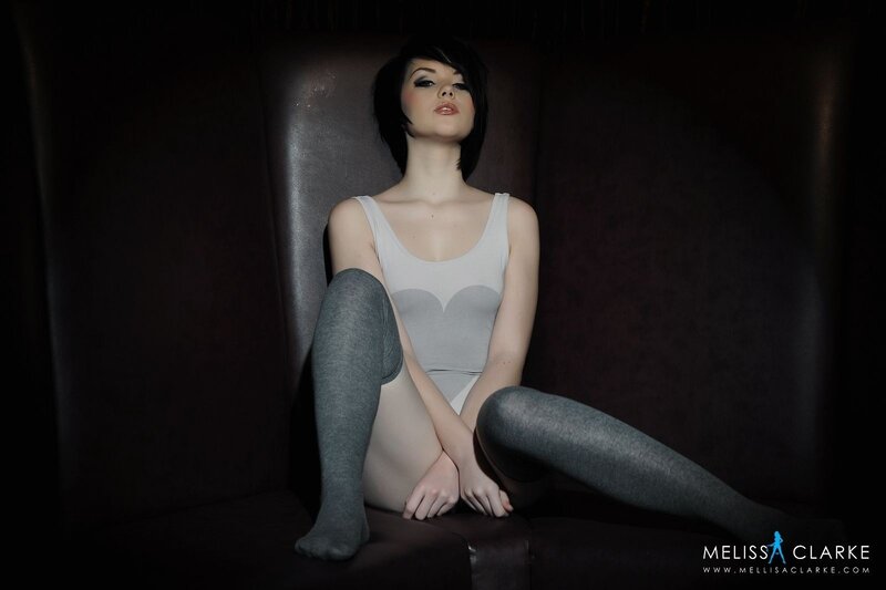 woman in bodysuit sitting