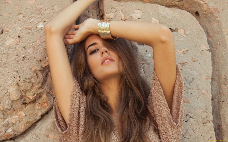 woman in boho style against stone wall