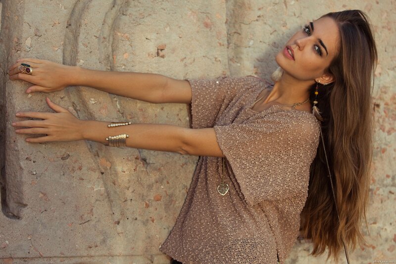 woman in boho style against stone wall