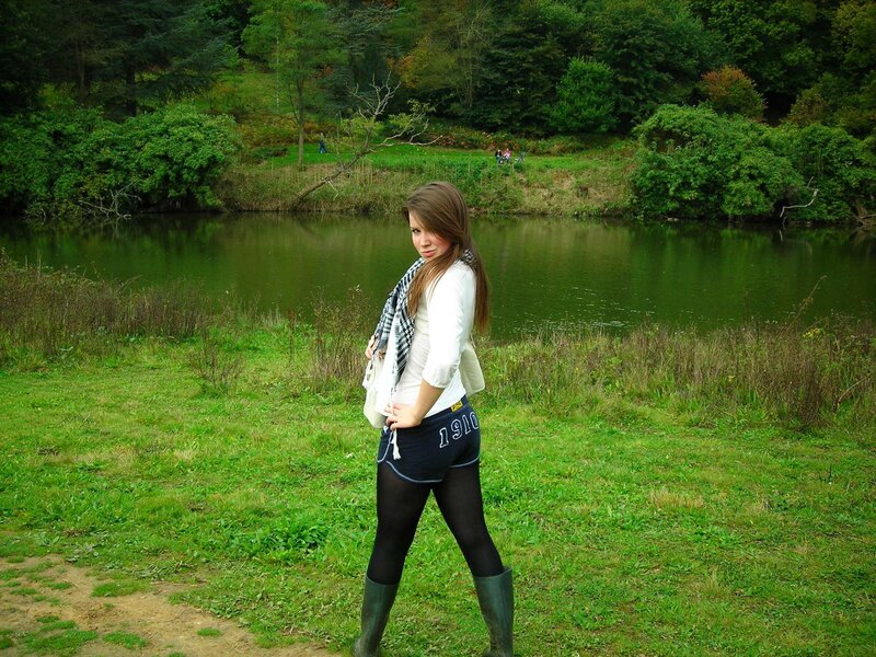 Woman in boots by a pond