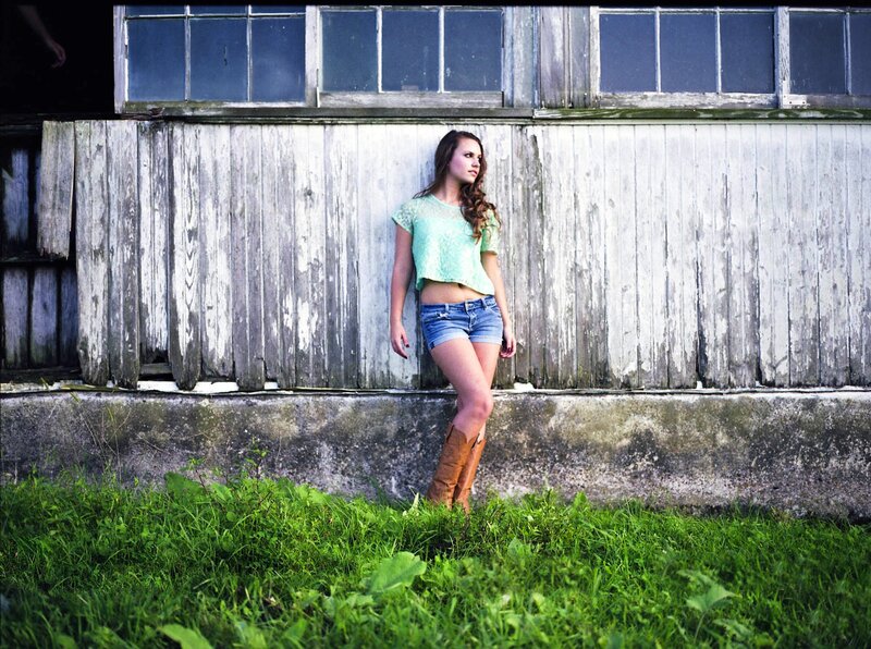 woman in boots by barn