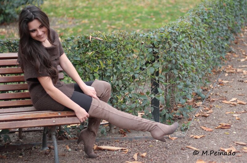 Woman in boots on a park bench