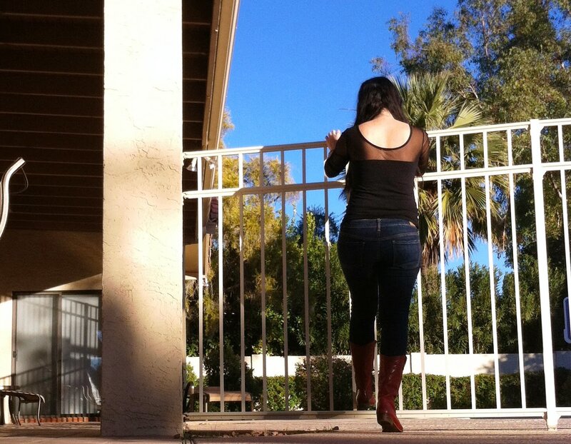 Woman in Boots on Balcony