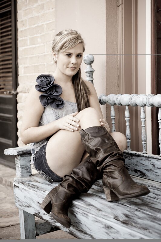 woman in boots on bench
