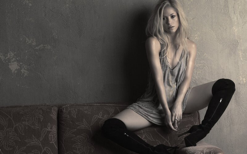 woman in boots sitting on couch
