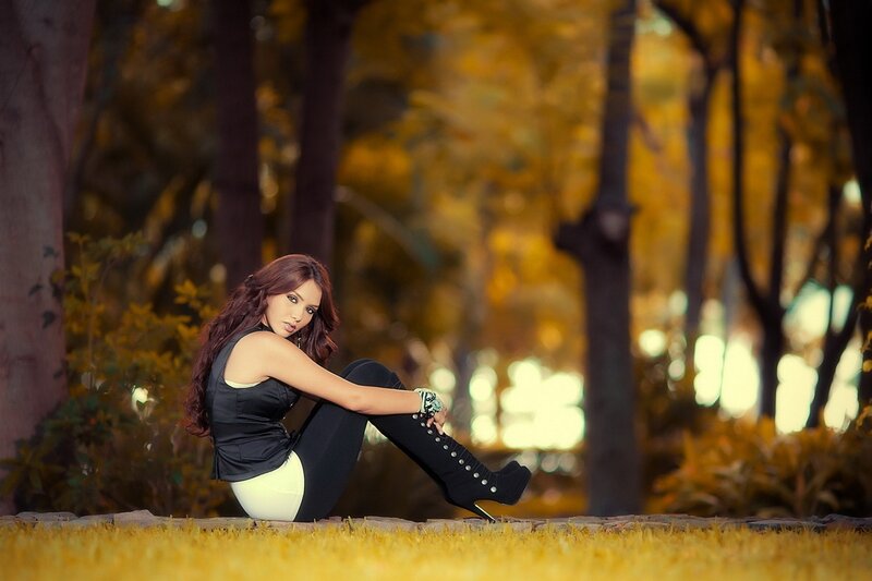 woman in boots sitting outdoors