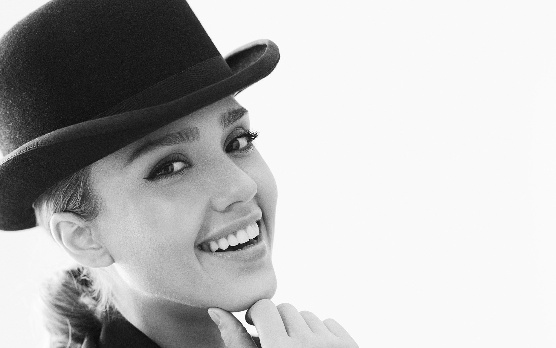 woman in bowler hat smiling