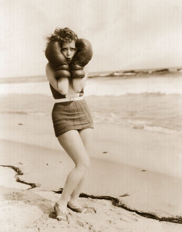 woman in boxing gloves on beach