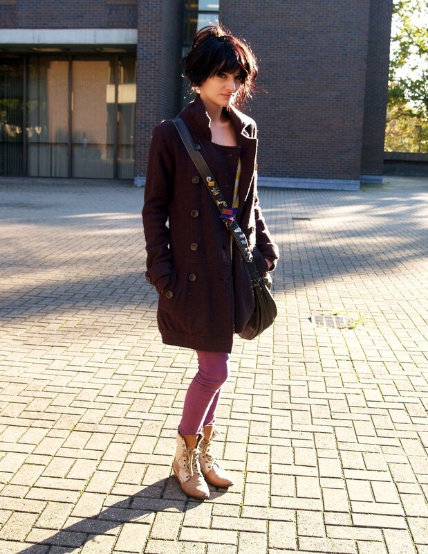 Woman in brown coat standing outside