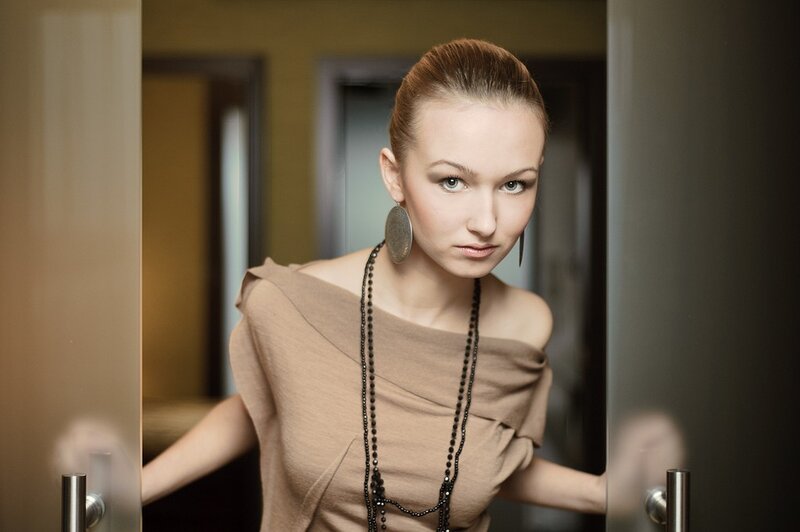 woman in brown dress looking at camera