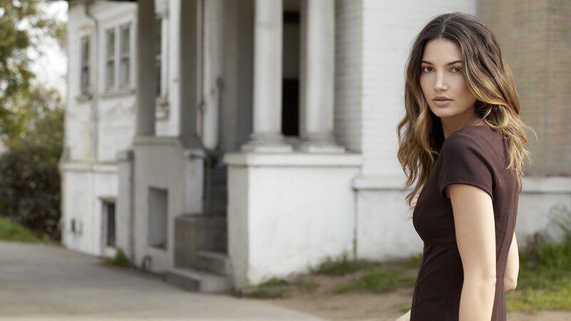 woman in brown dress outside house