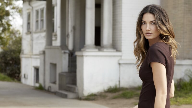 woman in brown dress outside house