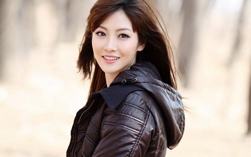 woman in brown jacket smiling