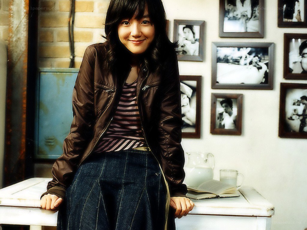 woman in brown jacket smiling