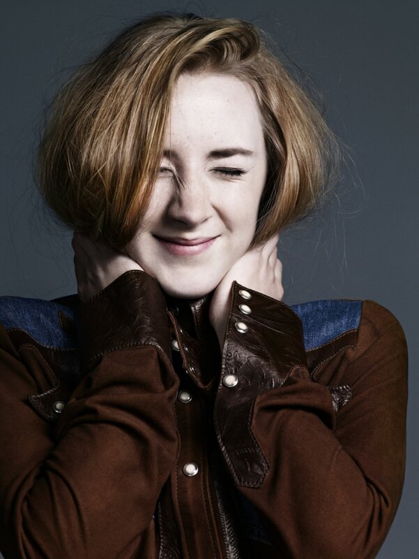 woman in brown jacket smiling