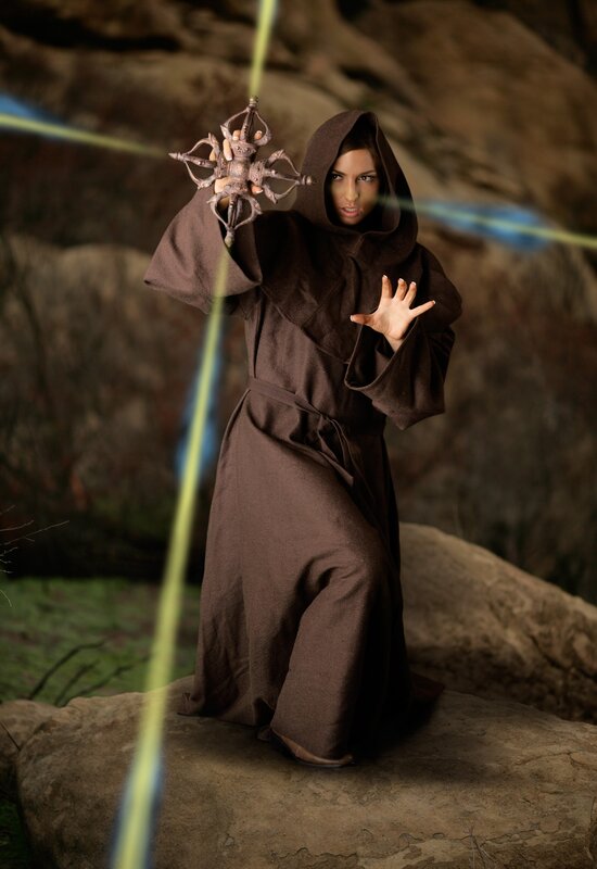 woman in brown robe with staff