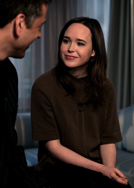 woman in brown sweater smiling