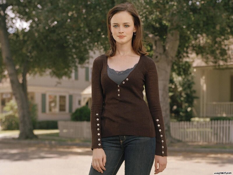 woman in brown sweater standing outside
