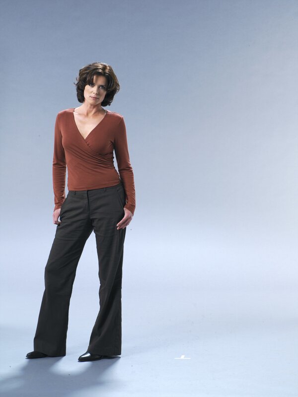 woman in brown top and black pants