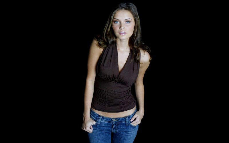 Woman in Brown Top — Confident, Photograph, Jeans, Black Background