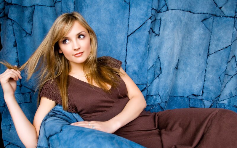 woman in brown top on blue couch