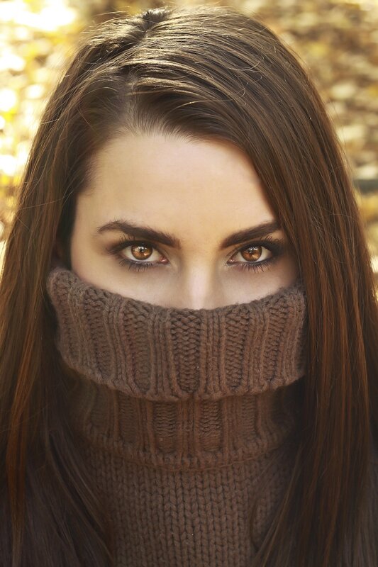 woman in brown turtleneck