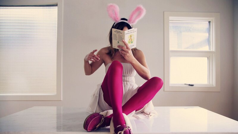 woman in bunny costume reading