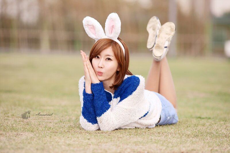 woman in bunny ears on grass