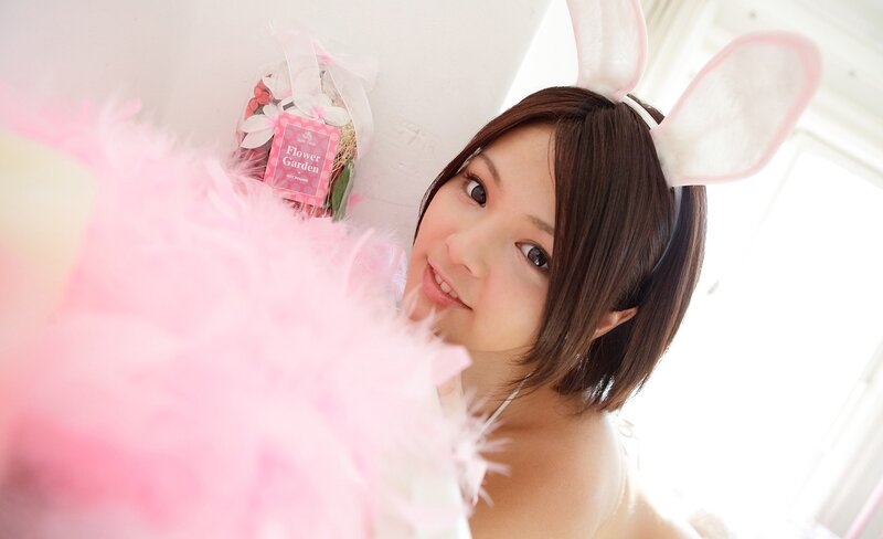 woman in bunny ears with pink feathers
