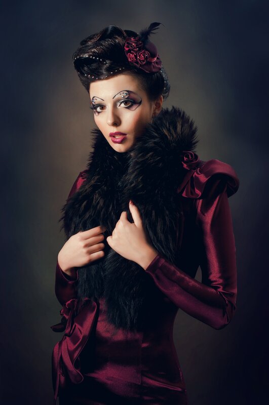 woman in burgundy dress with fur collar