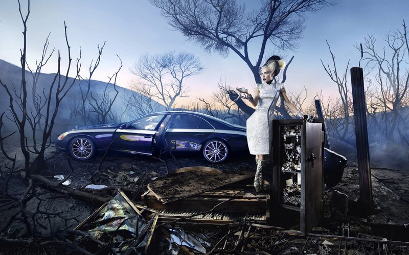 woman in burned landscape with car
