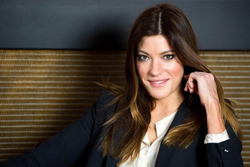 woman in business attire smiling