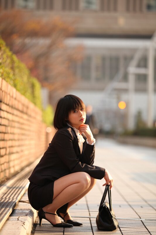 woman in business suit crouching