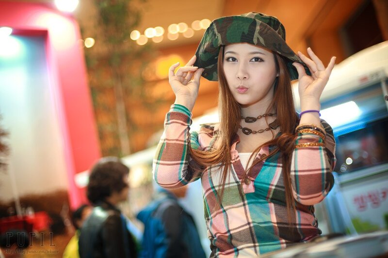 Woman in camouflage hat at event