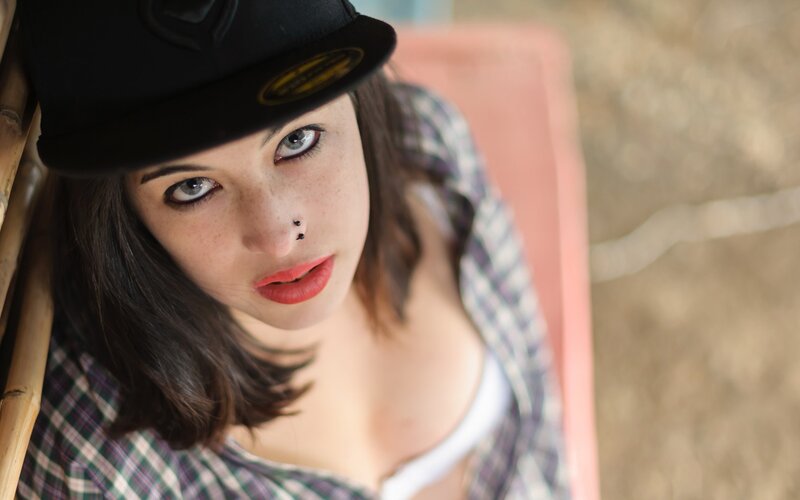 woman in cap and plaid shirt
