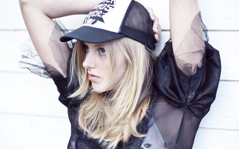 woman in cap and sheer top