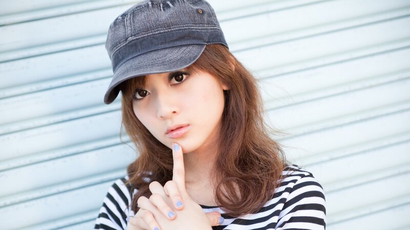woman in cap and striped shirt