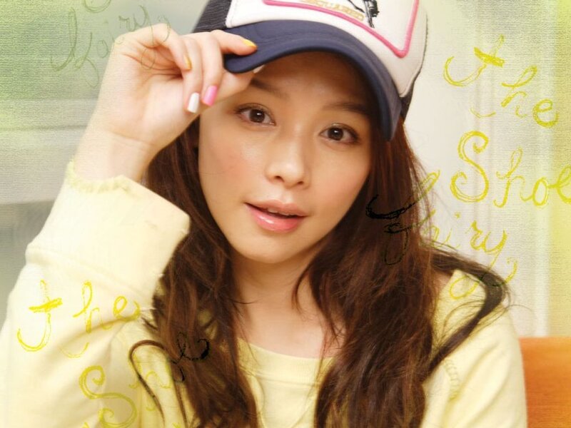 woman in cap and yellow sweater