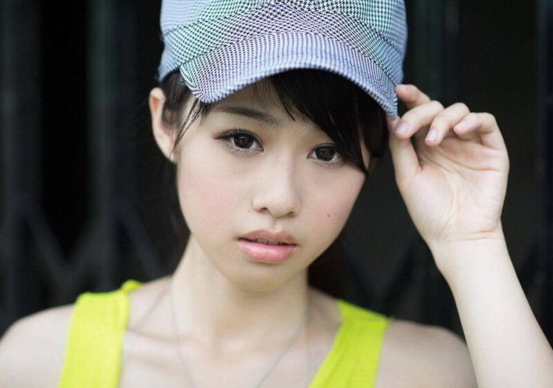 woman in cap and yellow top