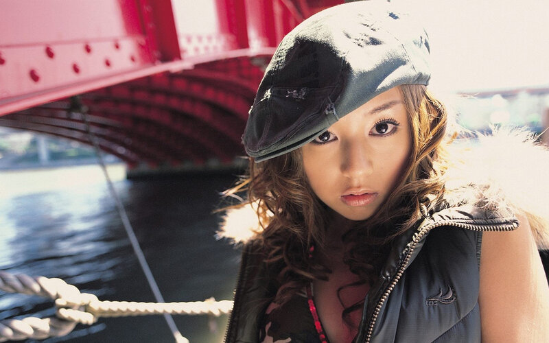 woman in cap by red bridge
