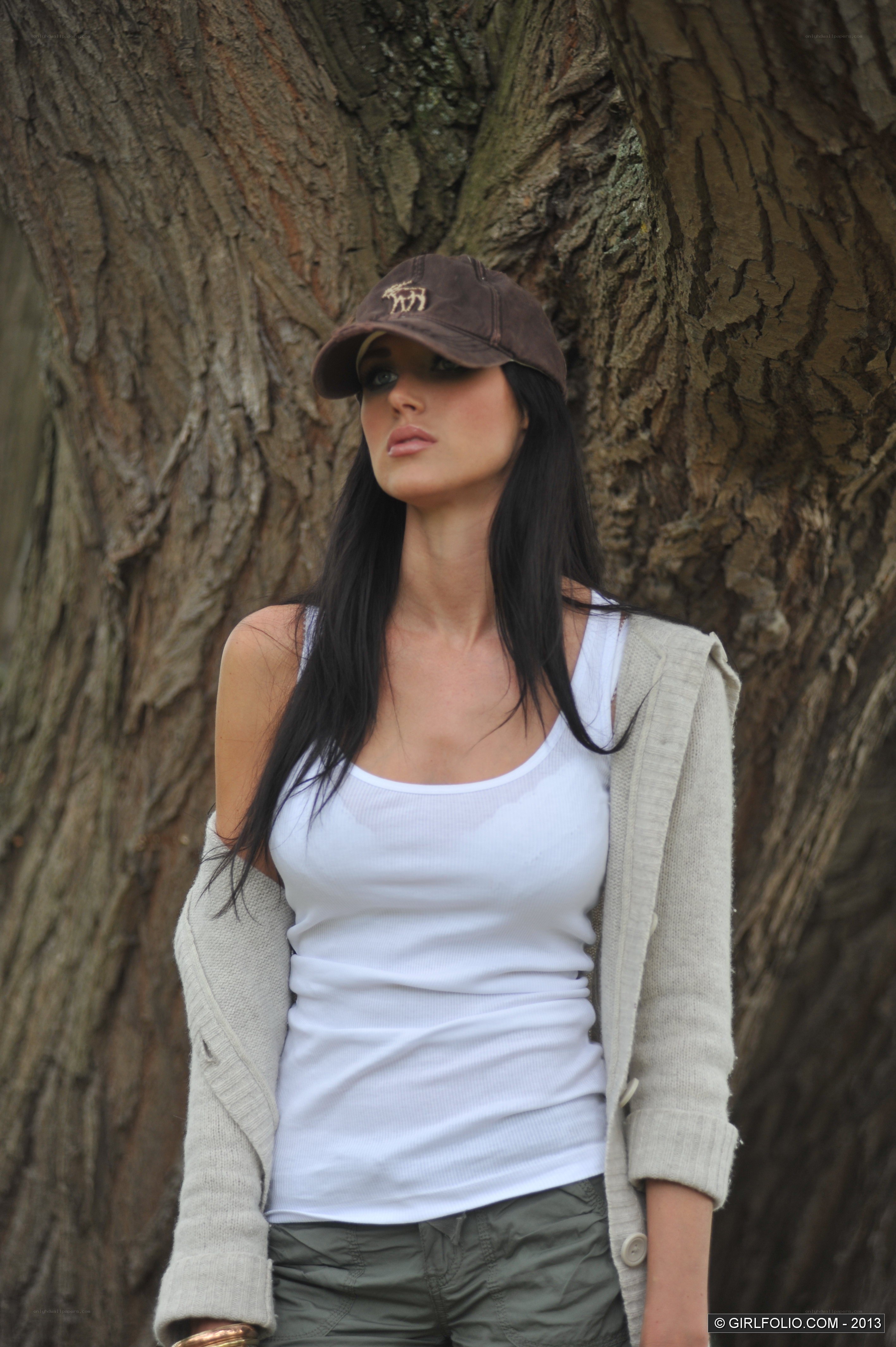 Woman in cap by tree