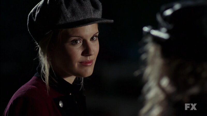 woman in cap looking at someone