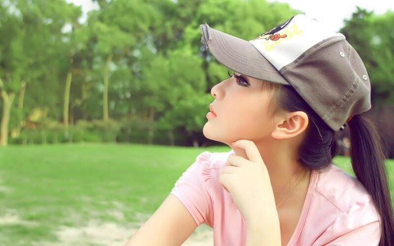 woman in cap looking up