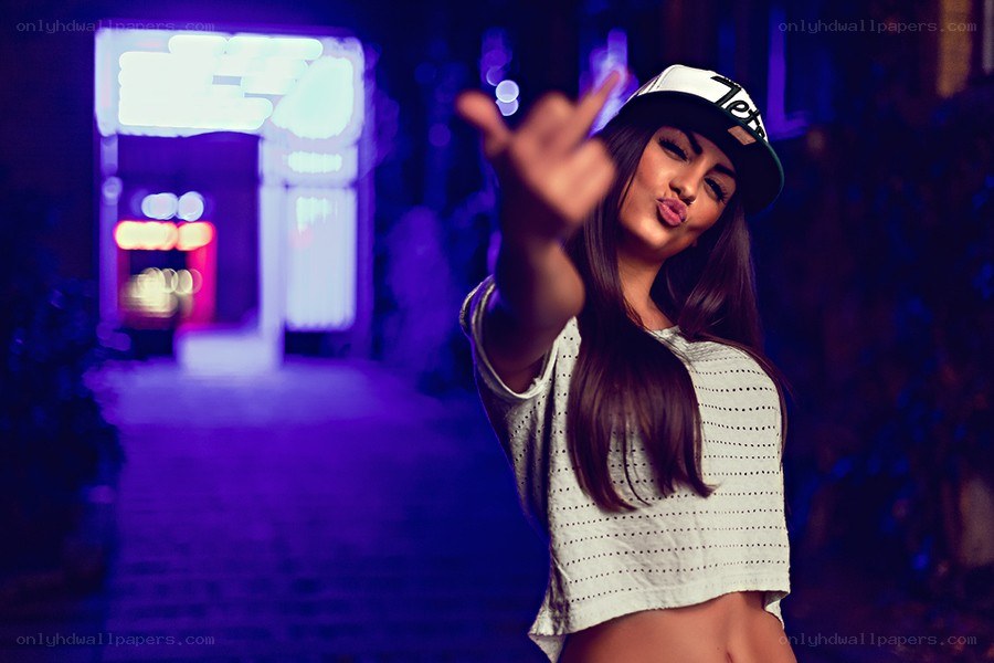 woman in cap making hand gesture