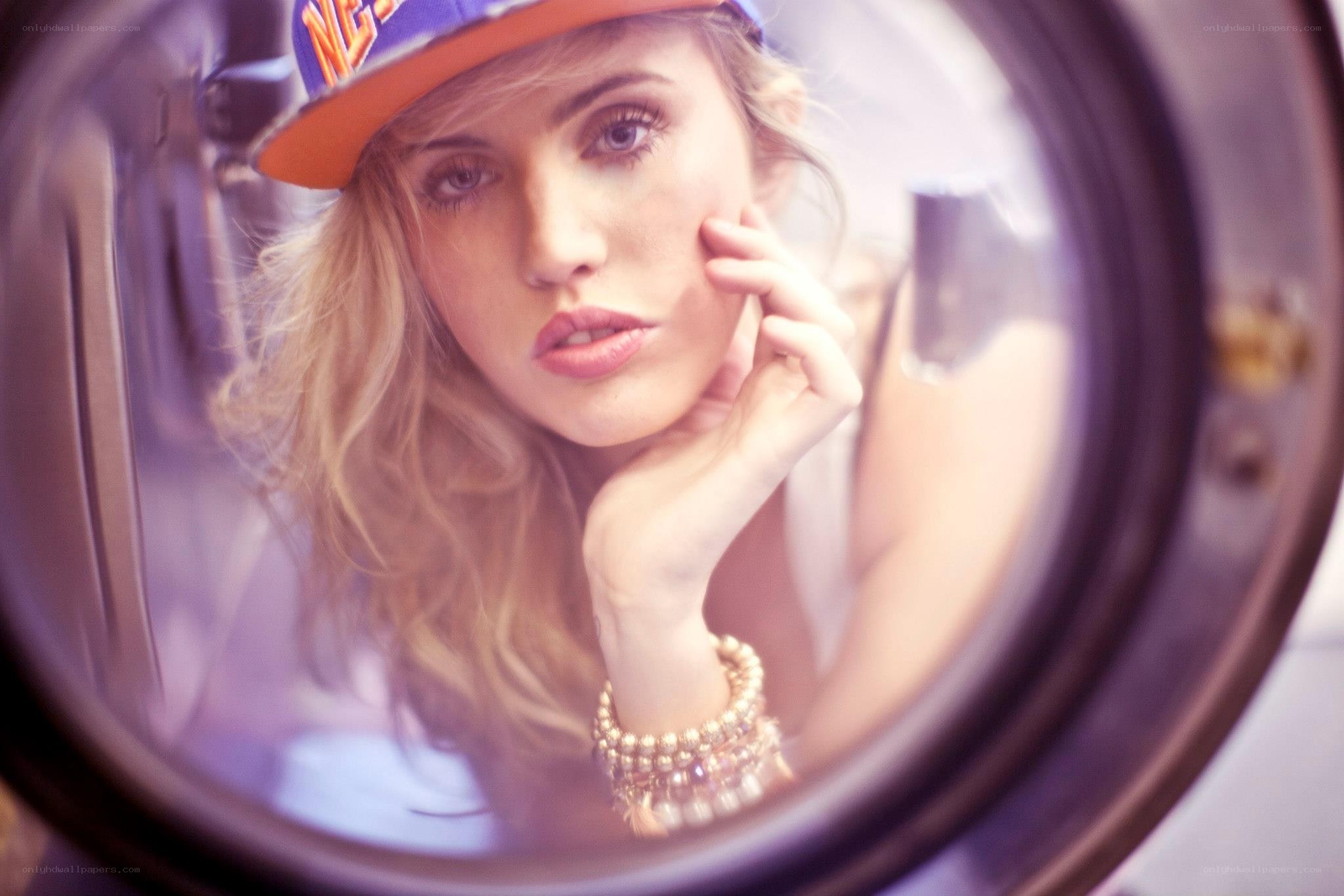 woman in cap reflected in mirror
