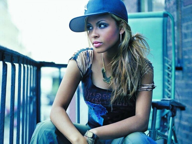 woman in cap sitting on balcony