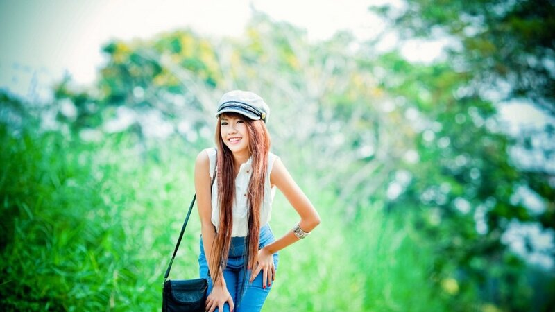 woman in cap smiling outdoors